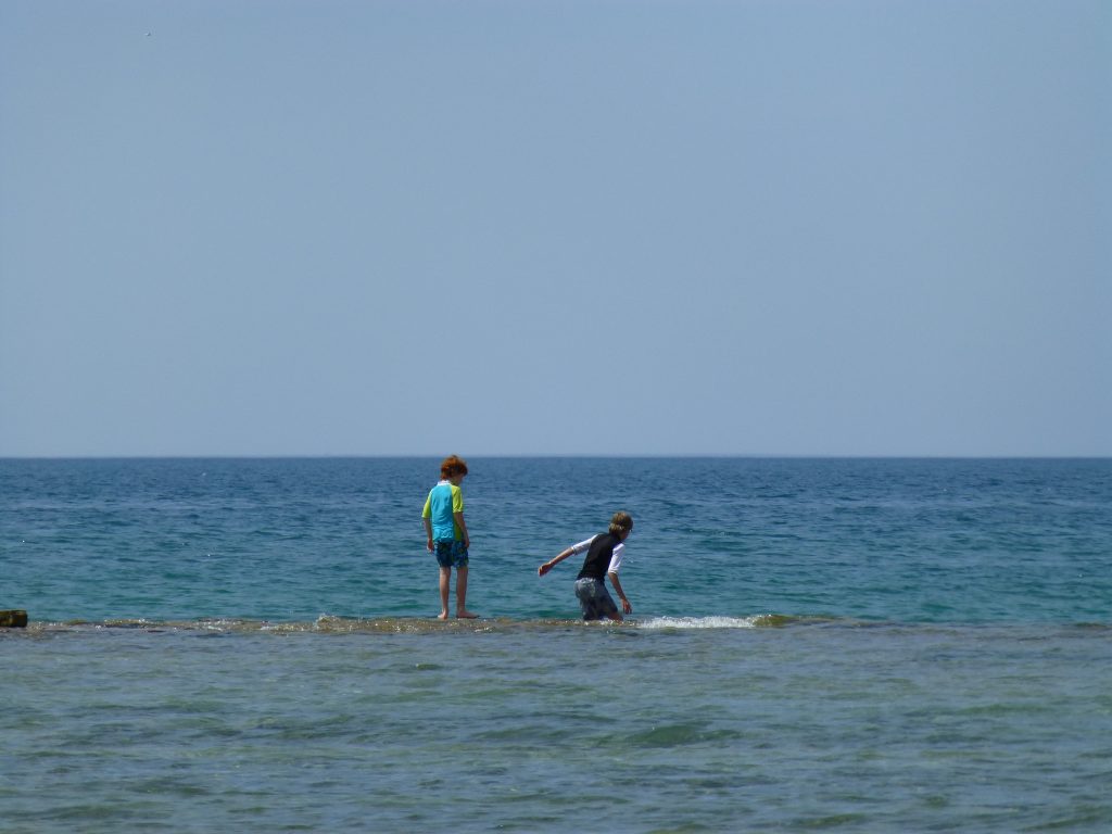 picture of kids in Lake Huron on the beach at Inverhuron Provincial Park