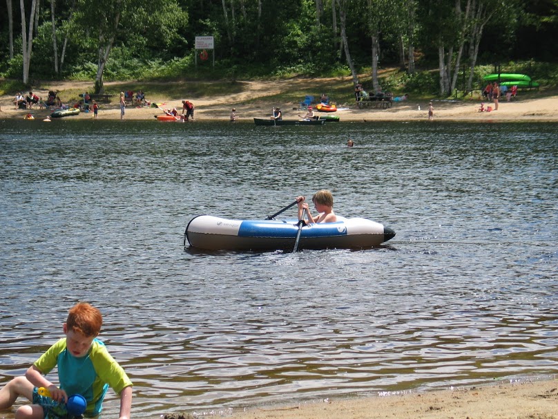 kids playing on the beach and in a boat at Arrowhead Lake