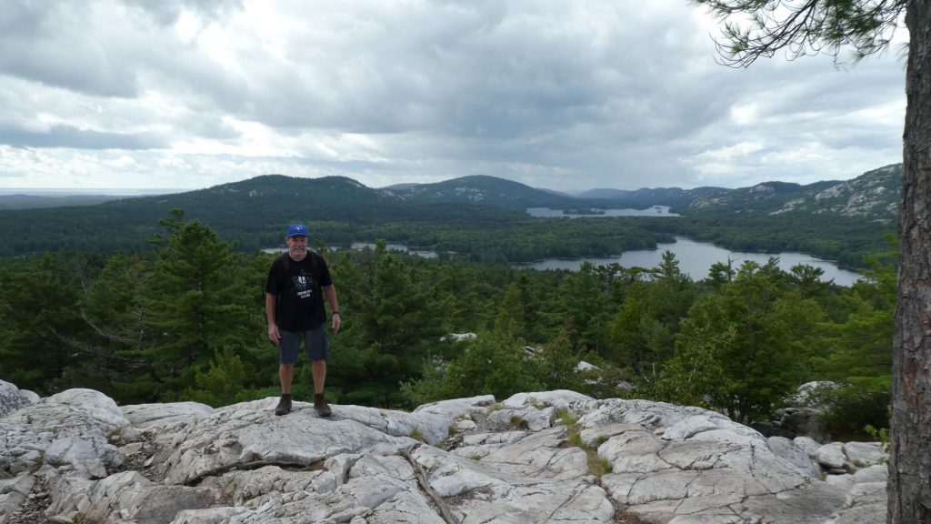 Tim standing on the white rocks at the top of The Crack at Killarney Provincial Park 