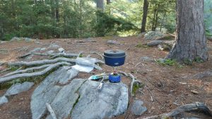 picture of backcountry cooking with a bugaboo pot cooking over a pocket rocket burner 