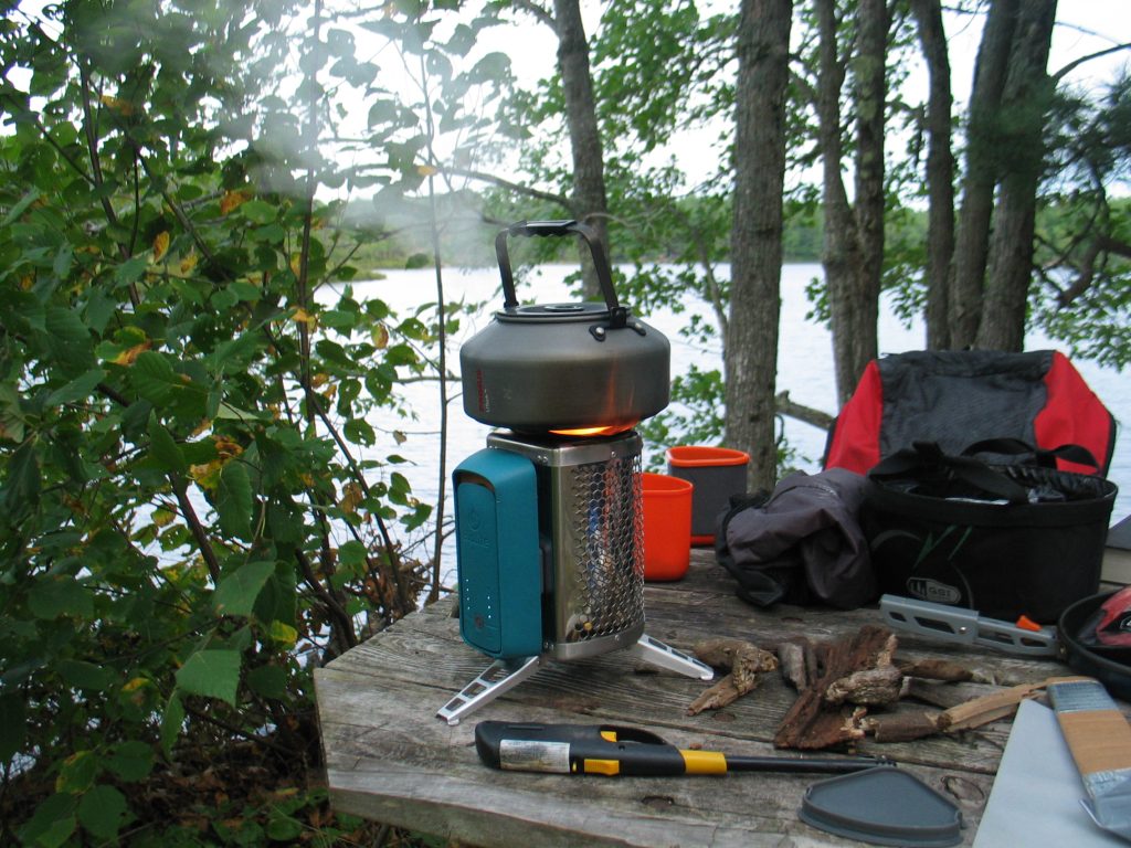 picture of a picnic table with a biolite camp stove, bugaboo camping set, for cooking while backcountry camping