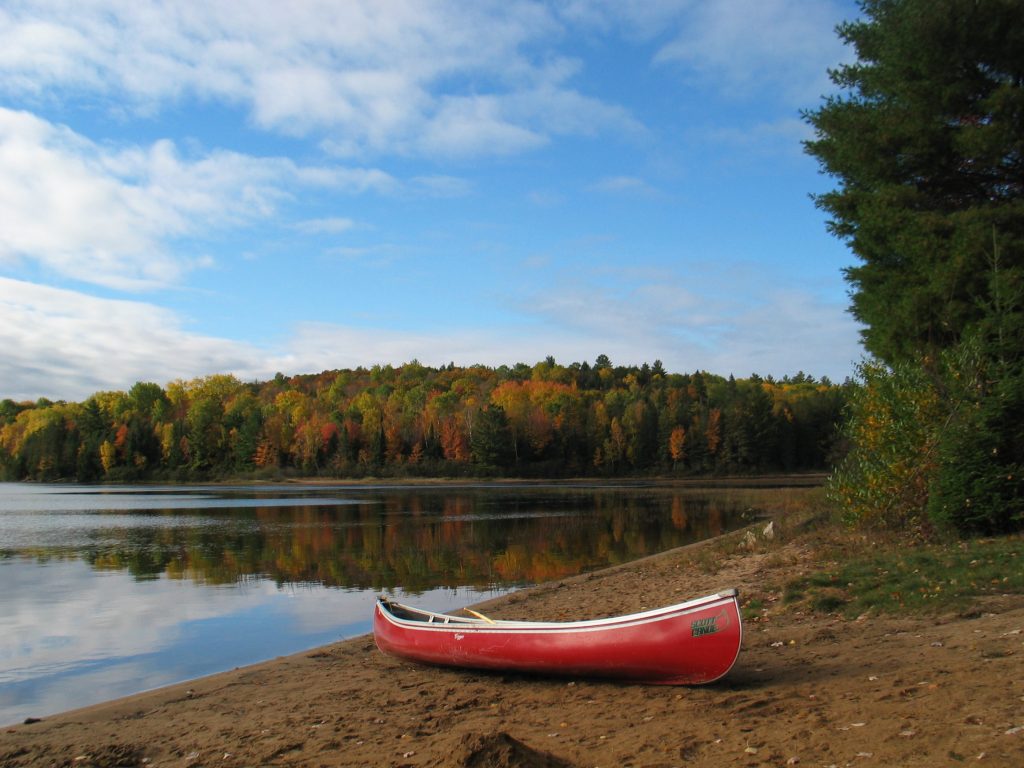 picture of a canoe by a lake while backcountry camping in Kawartha Highlands Provincial Park in the fall