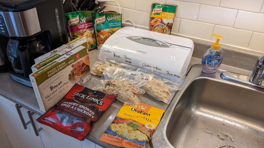 picture of a vacuum sealer and dehydrated food for backcountry camping