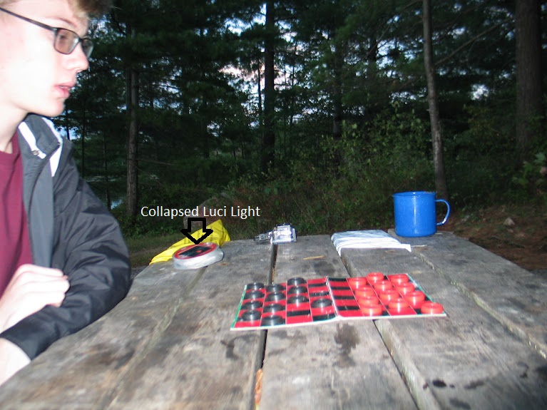 picture of a man at a picnic table while backcountry camping and playing checkers