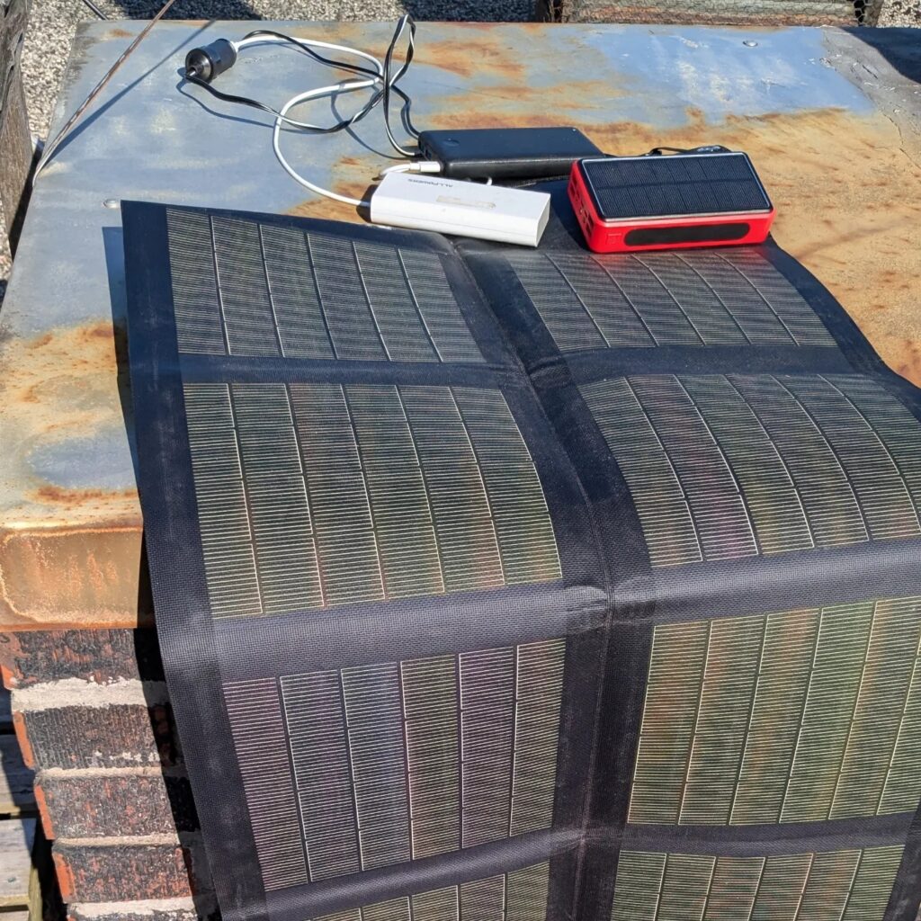 picture of a solar panel charging a power bank for camping