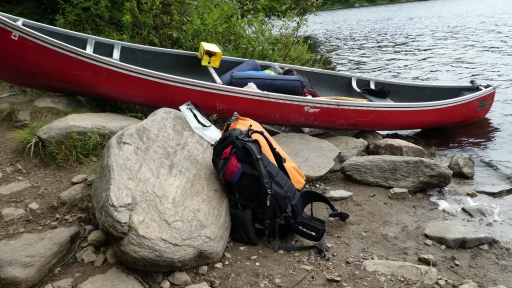 picture of a canoe and a backpack for backcountry camping